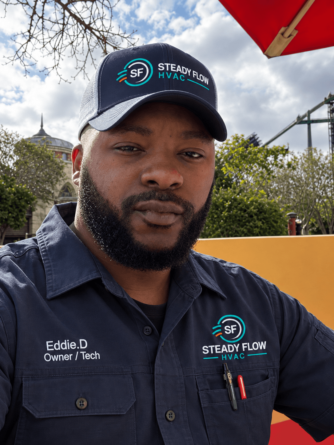 Eddie D., Steady Flow HVAC owner-technician, wearing a branded work shirt and cap